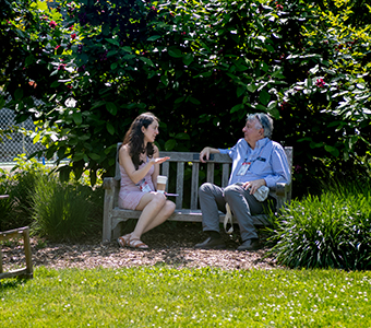 Two people talking on a bench. Links to Gifts from Retirement Plans Two people talking on a bench. Links to Gifts from Retirement Plans